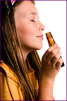 Woman Smelling Essential Oil Directly Out of the Bottle