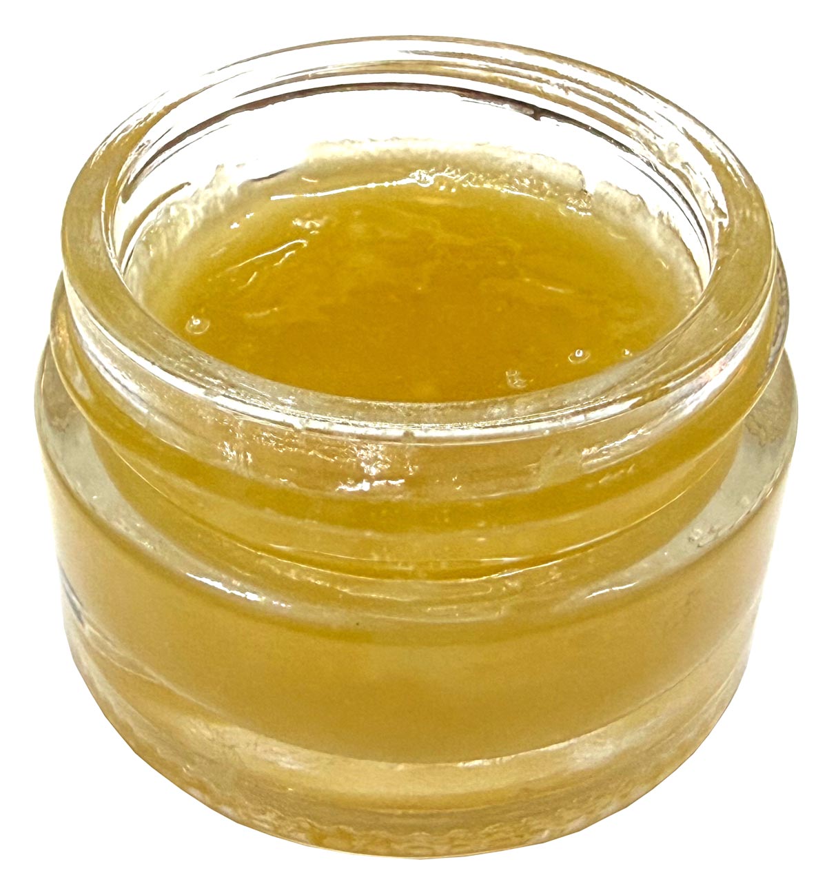 Clear glass jar filled with Guaiacwood Essential Oil showing the thickness of the oil at room temperature