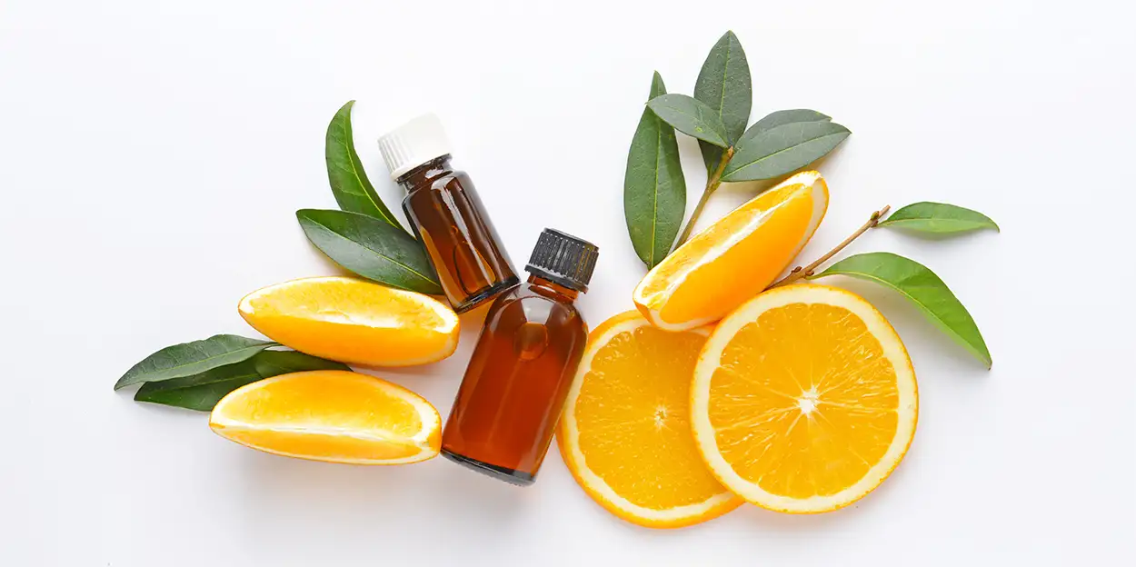 Bottles of Essential Oils for Aromatherapy Surrounded by Fresh Orange Slices